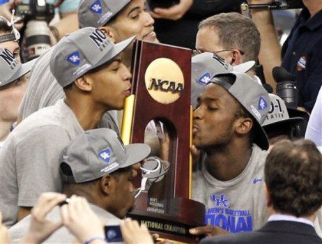 Kentucky forward Anthony Davis, left, and forward Michael Kidd-Gilchrist, right, kiss the trophy after the NCAA Final Four tournament college basketball championship game Tuesday, April 3, 2012, in New Orleans. Kentucky beat Kansas 67-59. (AP Photo/Bill Haber)